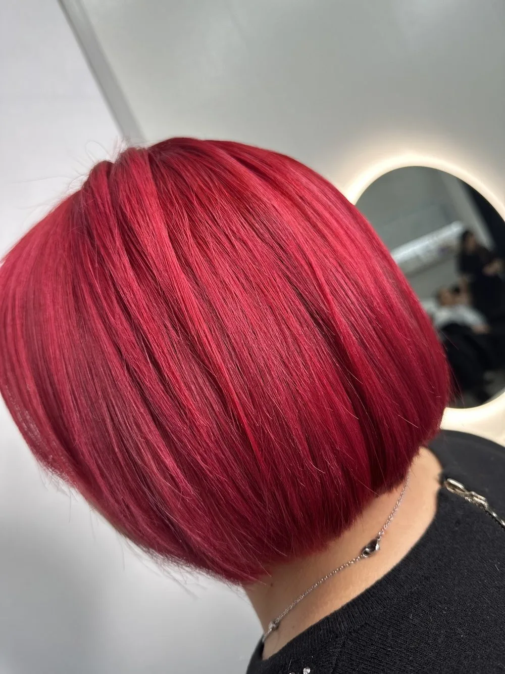 Caschetto rosso realizzato da Hair Love Parrucchieri, davanti allo specchio del salone